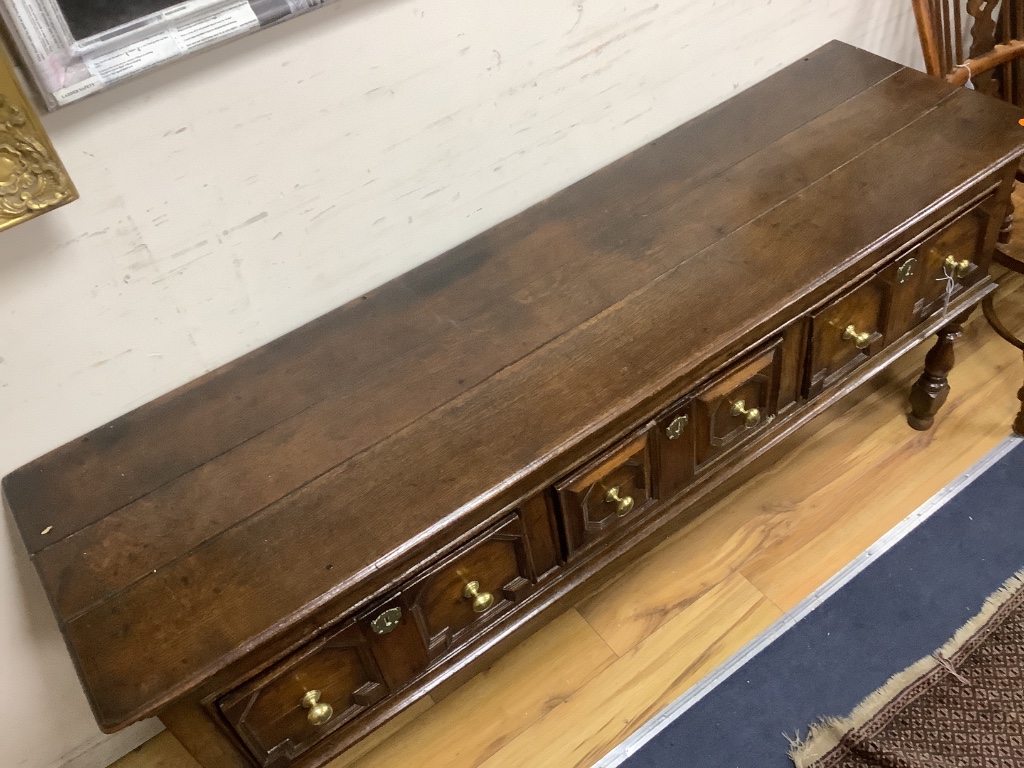 A Charles II oak dresser, fitted three drawers, with geometric mounted fronts